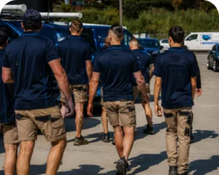 Plumbers walking to their service vans on a Russell Lea job